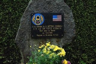 Memorial to an American airman outside country graveyard near St James, France
