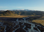 Glacial-river-with-mountains-beyond